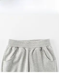 Detail view of boys' light grey knit shorts featuring elastic waistband and side pockets