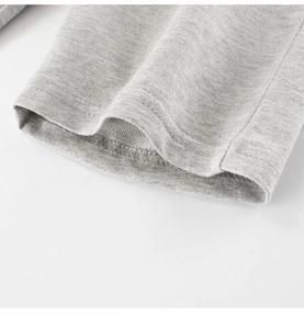 Detailed macro view of gray French Terry cotton knit fabric with reinforced flat stitching