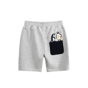 Detail of grey knitted boys' shorts featuring an elastic waistband and cute penguin patch pocket