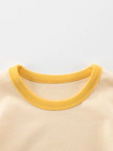Short sleeve toddler dinosaur t-shirt with bright yellow ribbed crew neck detail