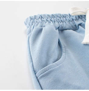 Close-up of boys light blue breathable mesh shorts with elastic waist and white drawstring