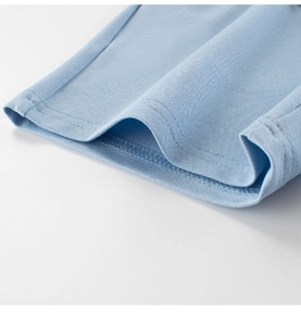 Macro detail of light blue mesh fabric showing high-quality double stitching on hem