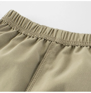 Detail of children's khaki joggers featuring elastic waistband and reinforced stitching