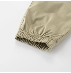 Detail of elastic cuff on khaki quick-dry summer pants for boys with soft fabric texture