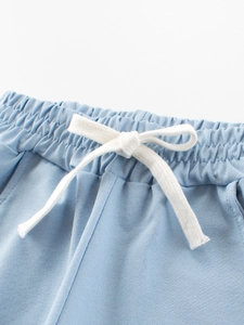Kids light blue mesh shorts with elastic waist and white cotton drawstring detail