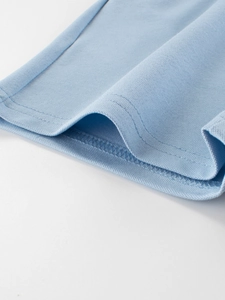 Close-up of light blue mesh breathable fabric showing fine double-needle stitching quality