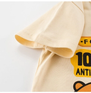 Close-up of cotton baby tee sleeve with neat stitching and colorful cartoon print