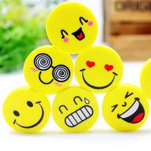 Set of round yellow smiley face erasers for kids stacked in a pyramid shape