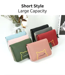 Detailed view of six pastel coin purses with cat prints and star zipper pulls