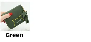Close-up of green mini cat coin purse with zipper and elegant tassel detail