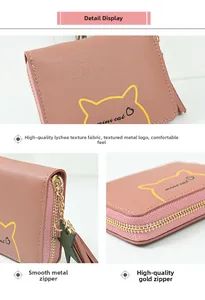 Close-up of pink coin purse with gold zipper, star charm, and leather tassel detail