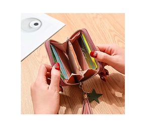 Pink zip-around wallet with tassels showing large capacity accordion card slots