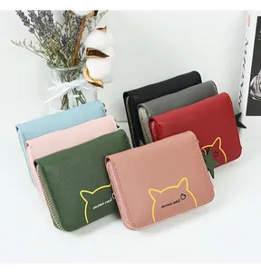 Close-up of colorful PU leather coin purses with mini cat design and star pendants