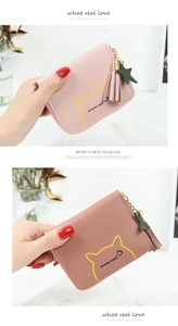 Close-up of pebble grain PU leather coin purse with cute cat print and tassel zipper
