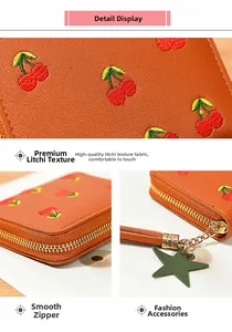 Detail of cherry embroidery on litchi grain faux leather wallet with star pendant