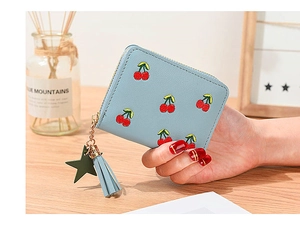 Detail of light blue cherry embroidered wallet with zipper and tassel charm