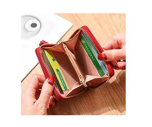 Macro view of red leather wallet interior with card slots and zipper coin pocket