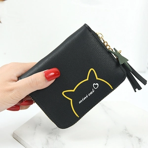 Compact black zipper coin purse with cute cat design and green star tassel charm