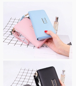 Detail of long zippered PU leather wallets with star pattern, tassel, and wrist strap