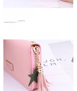 Detail of pink long wallet with star charm, tassel, and metallic Forever Young logo