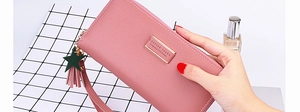 Detail of pink faux leather long wallet with star tassel, zip closure and wrist strap