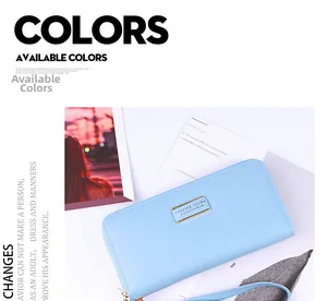 Detail of light blue faux leather long wallet with gold logo plate and wrist strap