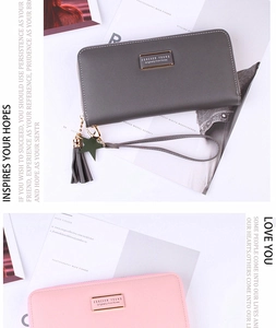 Detail of long PU leather wallets with tassels and star pendants in grey and pink