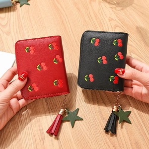 Short zipper wallet with cherry embroidery, lychee leather and fringe charm in red and black