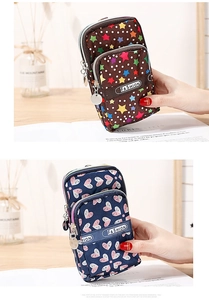 Detailed view of three-zip oxford cloth mobile phone bags in brown stars and blue hearts