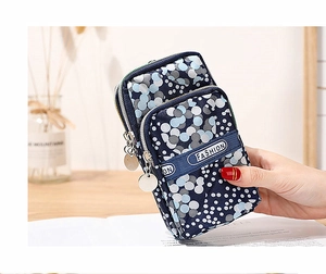 Close-up of a three-layer floral zipper phone pouch made of waterproof navy polka dot fabric
