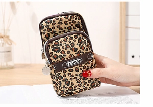 Detail view of leopard print phone bag with three zippered layers and fashion webbing