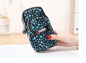 Close-up of a three-layer floral mobile phone bag with blue polka dots and fashion logo