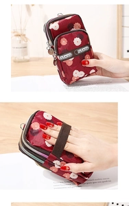 Three-layer burgundy floral phone bag with zippers and an elastic wristband detail