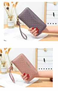 Detail of long floral leather zip wallets in purple and pink with tassels and wrist straps