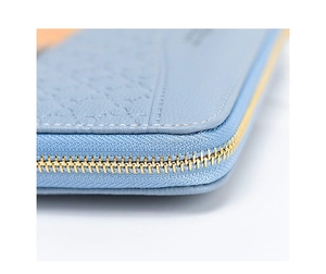 Macro detail of high-quality light blue leather wallet with gold metal zipper and stitching