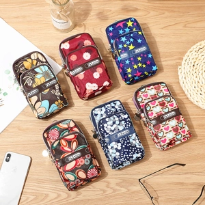 Waterproof floral phone bag with dual zippers in six patterns on wooden desk
