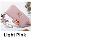Close-up of light pink long zip wallet with butterfly metal buckle and tassel strap