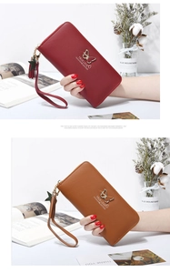 Detail of long zipper wallets with butterfly metal buckle and star tassel pendant