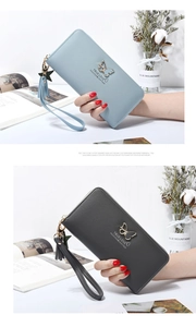 Close-up of long zip-around wallet with butterfly hardware and star tassel detail