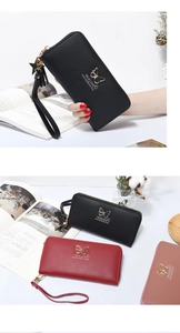 Detailed view of long zip wallets in black, red and pink with gold butterfly charms