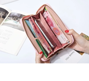 Detail view of pink leather long wallet showing multi-slot interior and large capacity