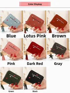 Detail view of colorful heart-embroidered long wallets with zippers and tassels