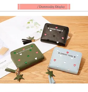 Close-up of three PU leather wallets with colorful heart embroidery and star charms