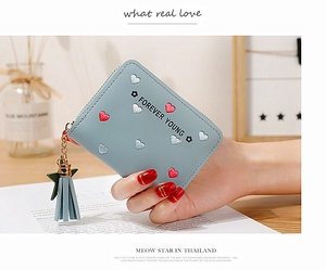 Detail of light blue PU leather wallet with heart embroidery and tassel star charm