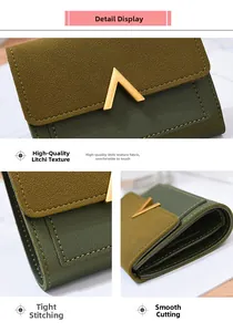 Close-up of women's dual-tone green wallet showing V-shaped metal buckle and neat stitching
