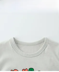 Detailed close-up of ribbed crew neck and stitching on a light grey cotton kids t-shirt