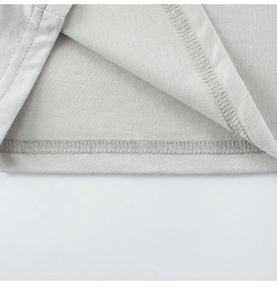 Detail of professional double-needle stitching on grey cotton knit t-shirt hemline
