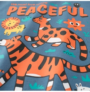 Close-up of blue cotton fabric featuring colorful cartoon animal prints and nature slogans