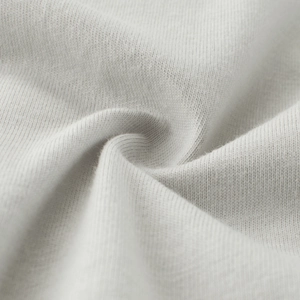 Close-up of soft grey cotton knit fabric texture with fine stitching for kids t-shirt