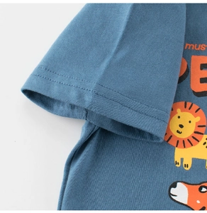 Macro detail of soft cotton knit blue kid t-shirt featuring a cartoon lion and text